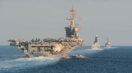 US rejects Iran strike claims as warships escort first ships through Hormuz