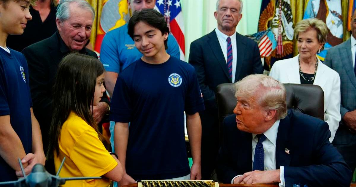 President Donald Trump speaks with children before signing a proclamation in the Oval Office at the White House, Tuesday, May 5, 2026, in Washington (AP Photo/Jacquelyn Martin)
