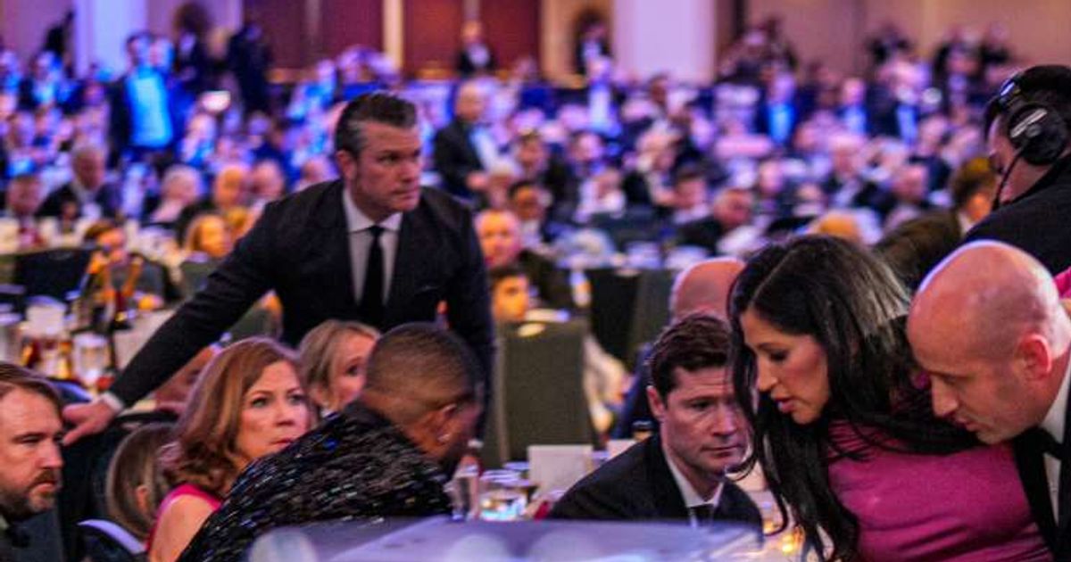 Pete Hegseth stands as Stephen Miller and his wife Katie Miller are taken out of the ballroom by security agents during a shooting incident at the annual White House Correspondents' Association Dinner (Getty Images)