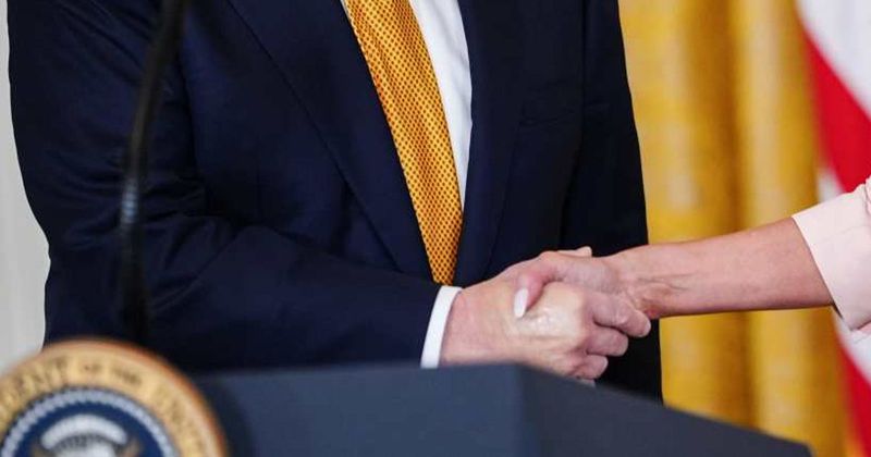 Trump’s swollen hands appear covered in makeup at White House amid growing health concerns