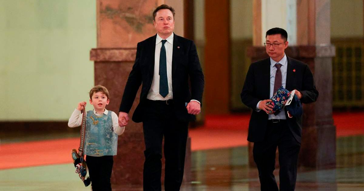Elon Musk added an unexpected personal touch to a meeting in Beijing by arriving with his six-year-old son, X Æ A-Xii (Go Nakamura/Pool Photo via AP)