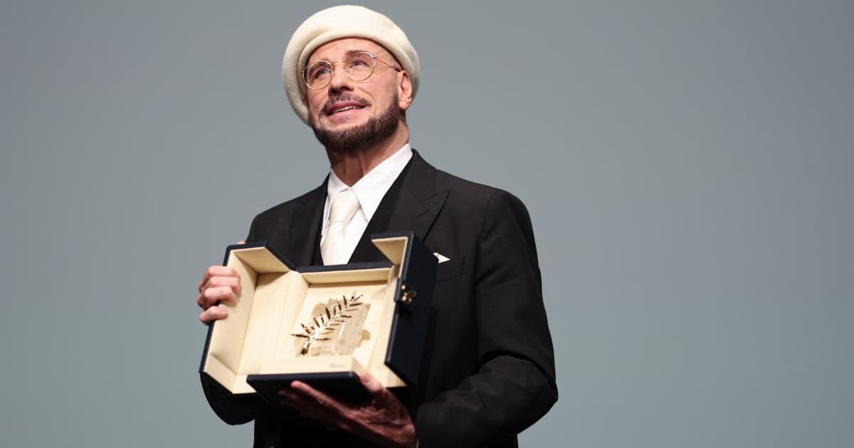 John Travolta accepts the Honorary Palme Award onstage during the 79th annual Cannes Film Festival at Plage Macé on May 15, 2026 in Cannes, France (Aurore Marechal/Getty Images)