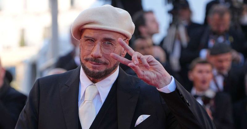John Travolta's wool beret look at Cannes 2026 draws attention as he receives honorary Palme d’Or