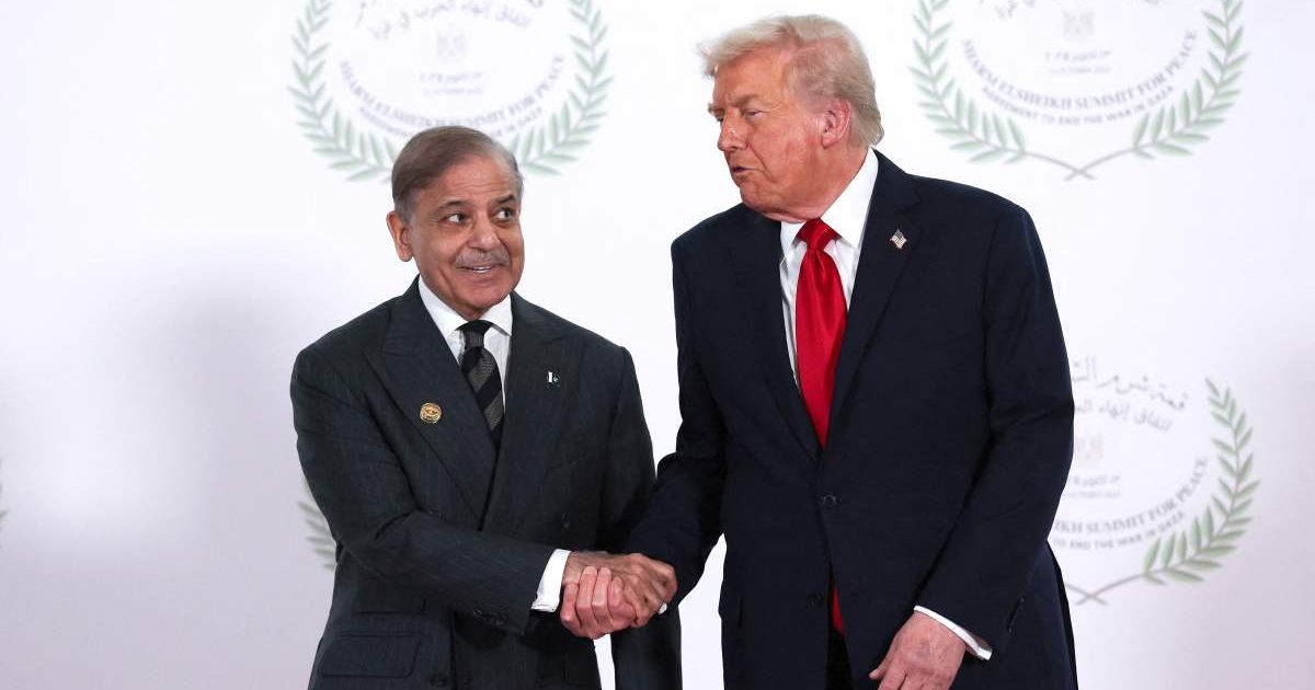 Donald Trump and Pakistani Prime Minister Shehbaz Sharif shake hands as they pose for a photo during a world leaders' summit on ending the Gaza war on October 13, 2025 (Getty Images)
