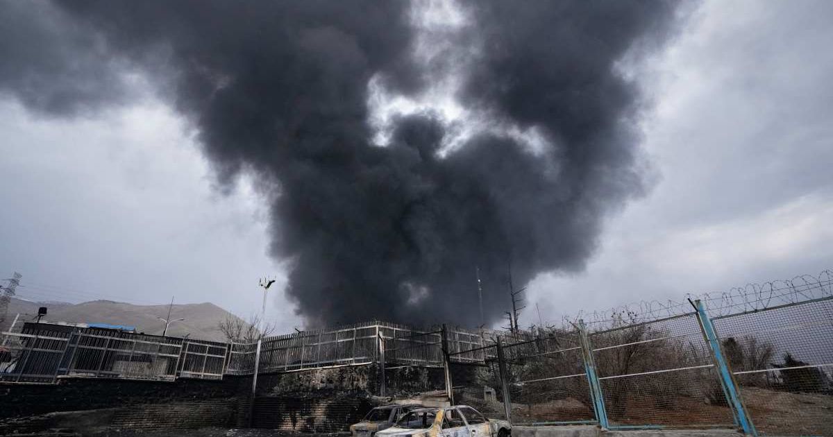 A thick plume of smoke rises from an oil storage facility hit by a US-Israeli strike late Saturday in Tehran, Iran, Sunday, March 8, 2026 (AP Photo/Vahid Salemi)