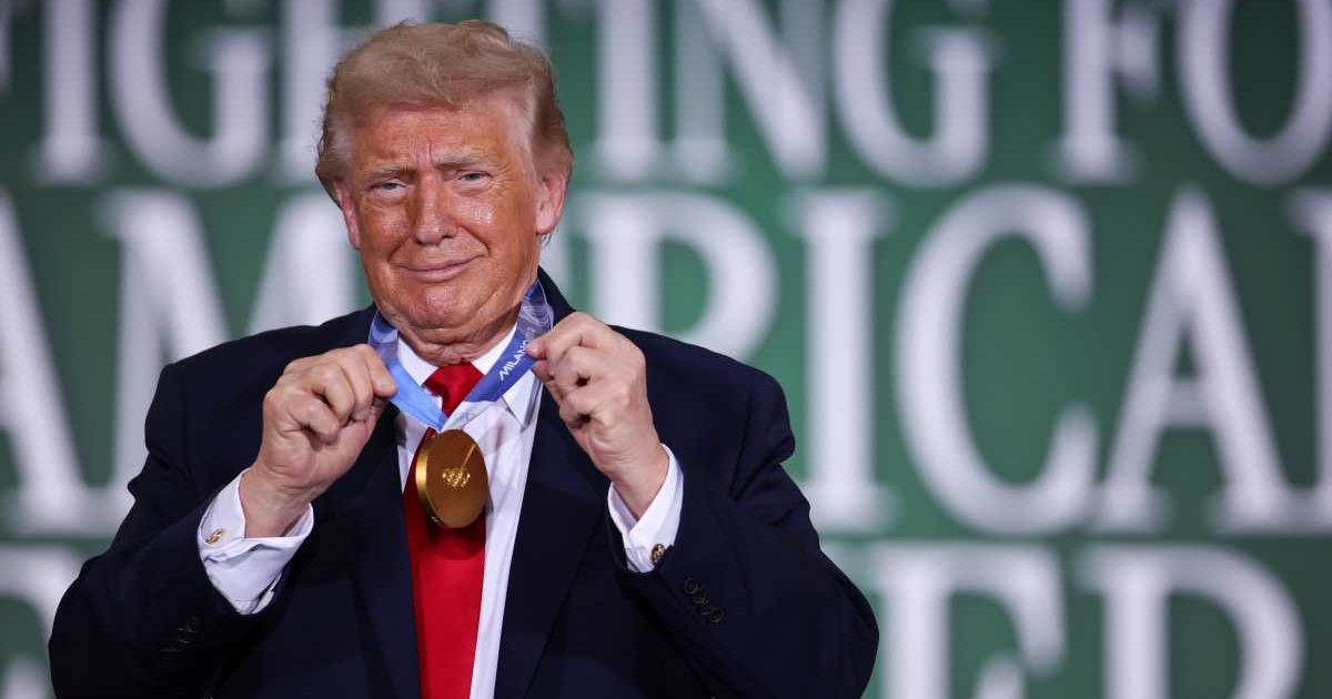 President Donald Trump wears the Olympic gold medal of Team USA speedskater Jordan Stolz during a roundtable on agriculture at Custer Farms in Chippewa Falls (Getty Images)