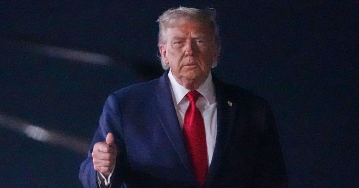 Donald Trump walks over to talk with reporters before boarding Air Force One at John F Kennedy International Airport (AP Photo/Mark Schiefelbein)