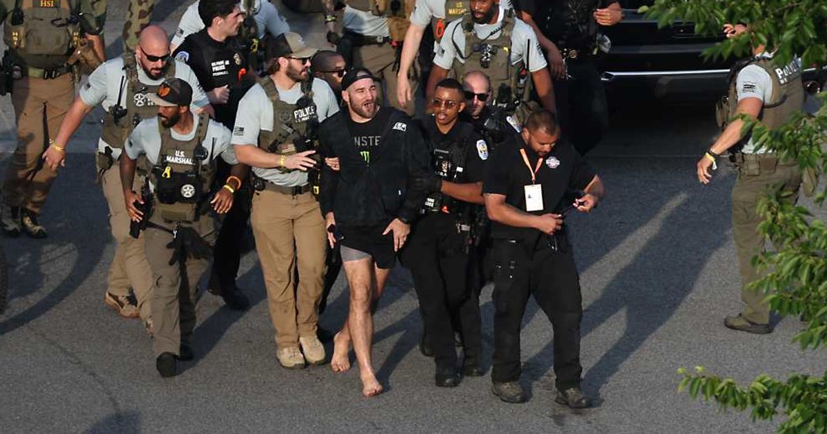 MMA fighter Sean Strickland is escorted out of the UFC Freedom 250 Fan Fest on The Ellipse by US Secret Service and other law enforcement ahead of UFC Freedom 250 on the South Lawn of the White House on Sunday, June 14 (Kevin Dietsch/Pool Photo via AP)