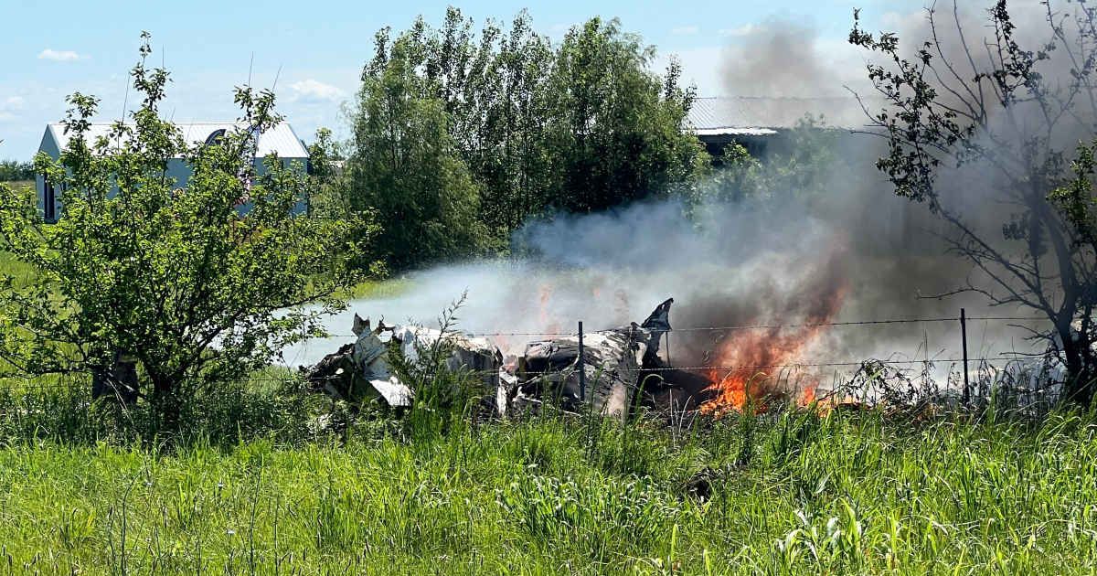 The wreckage of a plane crash burns in a field in Butler, Mo, Sunday, June 14, 2026 (Mid America News Review via AP Photo )