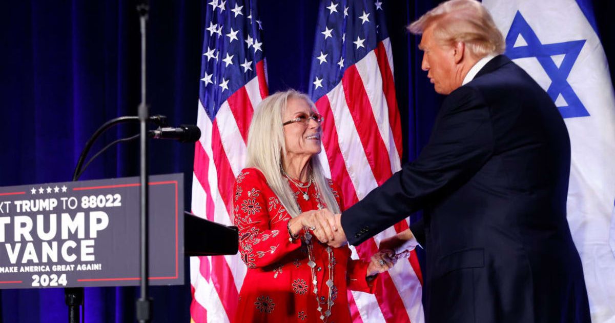Miriam Adelson, widow of billionaire casino magnate Sheldon Adelson, welcomes Donald Trump to the stage at the Hyatt Regency Capitol Hill in Washington, DC (Chip Somodevilla/Getty Images)