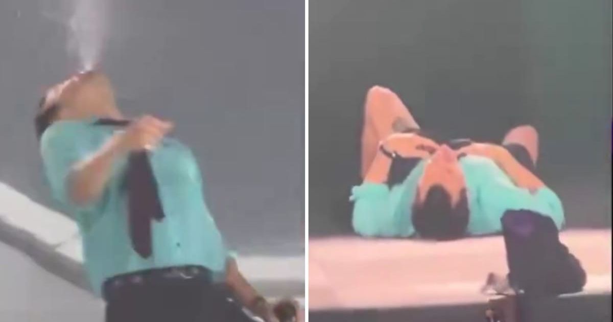 Harry Styles briefly choked on water and lay on the stage to regain his breath during his Wembley Stadium concert (@RT_com/X)