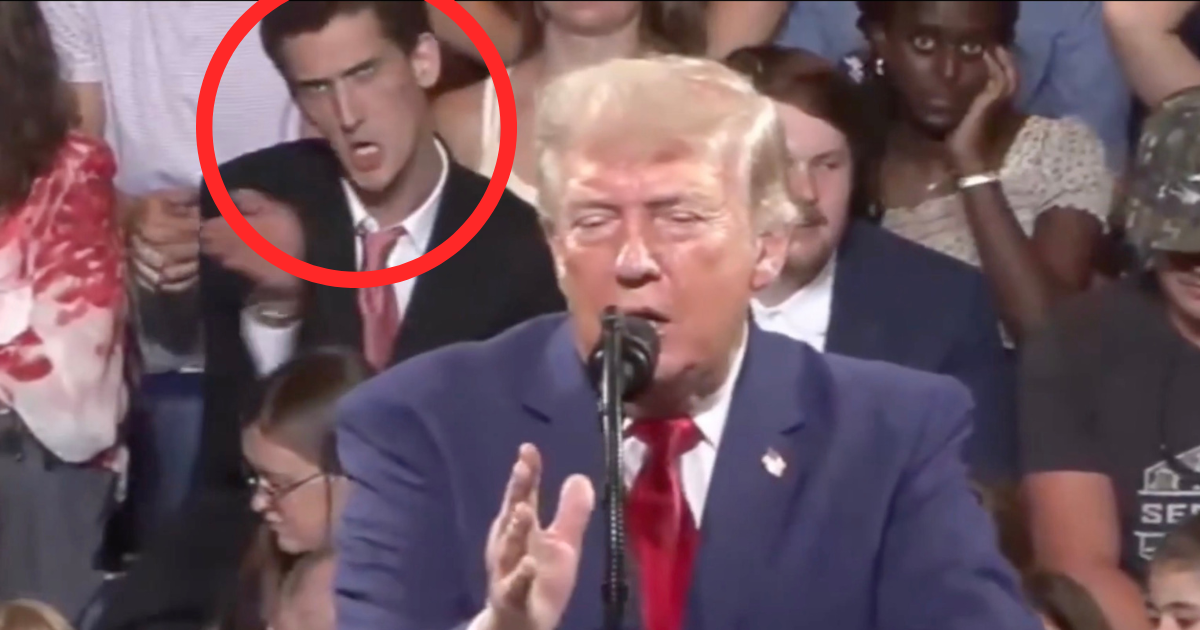 Donald Trump praised record US investment as a man behind him mimicked his signature hand gestures and repeated part of his speech (@EricLDaugh/X)