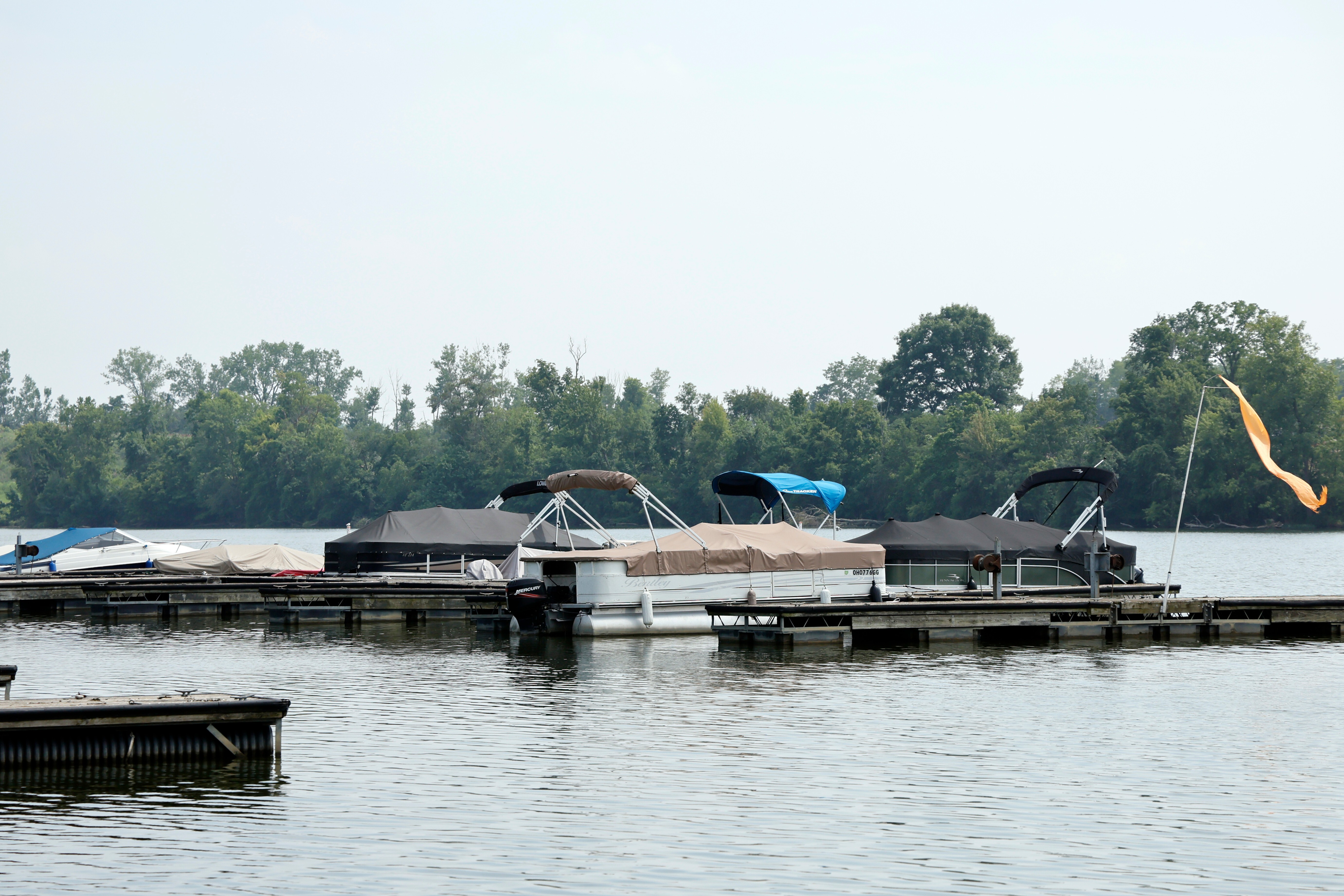 Officials stand at a staging area after an operation to recover multiple people who died while trying to save someone from the Scioto River in the Columbus suburb of Powell, Ohio, Monday, July 20, 2026