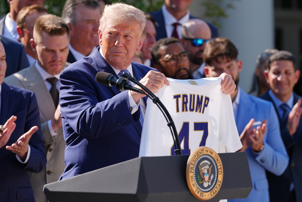 President Donald Trump holds up a Los Angeles Dodgers jersey during an event to honor the 2025 World Series champions Los Angeles Dodgers in the Rose Garden of the White House, Thursday, July 23, 2026, in Washington. (AP Photo/Julia Demaree Nikhinson)