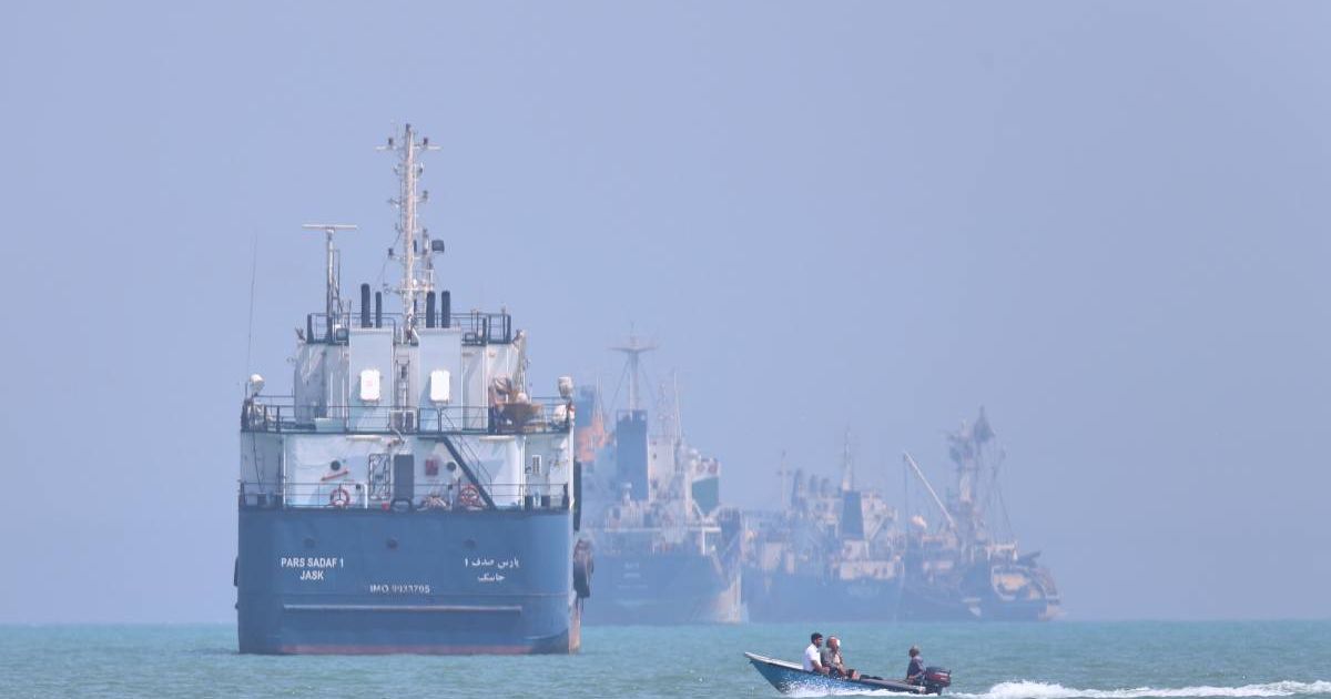 A small motorboat passes anchored vessels in the Strait of Hormuz off Bandar Abbas, Iran, Thursday, June 11, 2026 (Amirhosein Khorgooi/ISNA via AP)