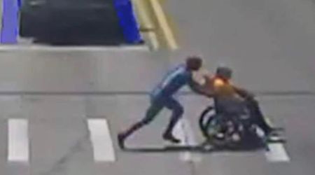 Watch: Man dressed as Spider-Man sprints across road to help stranded wheelchair user