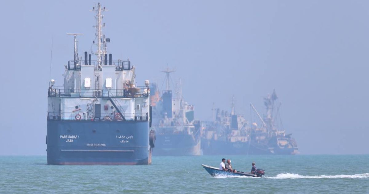 A small motorboat passes anchored vessels in the Strait of Hormuz off Bandar Abbas, Iran, Thursday, June 11, 2026 (Amirhosein Khorgooi/ISNA via AP)