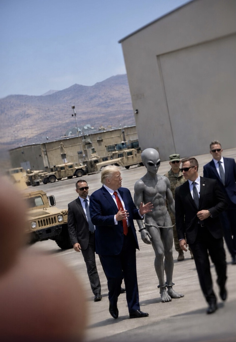 Another recycled image depicted Trump walking alongside officials while an alien in handcuffs was escorted away, reviving a meme that has circulated online before.