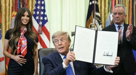 Who is the woman holding her stomach behind Trump: meet the viral White House face