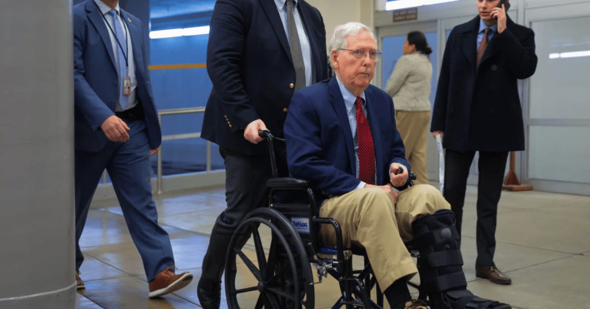 Mitch McConnell being assisted by staff as he goes to the Senate Chamber to vote on December, 11, 2024, in Washington, DC (Getty Images)