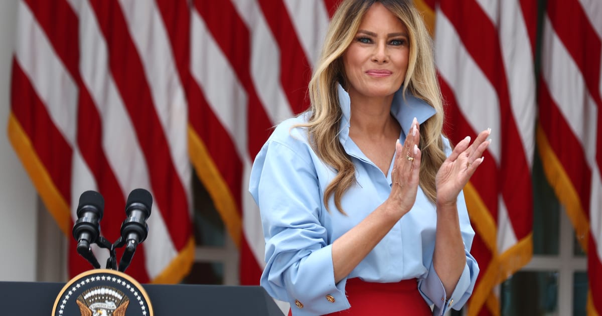 Melania Trump paired a sky-blue Michael Kors shirt and red Dior skirt with red enamel cufflinks featuring the presidential seal for an event in the White House Rose Garden on Thursday, August 20 (Getty Images)