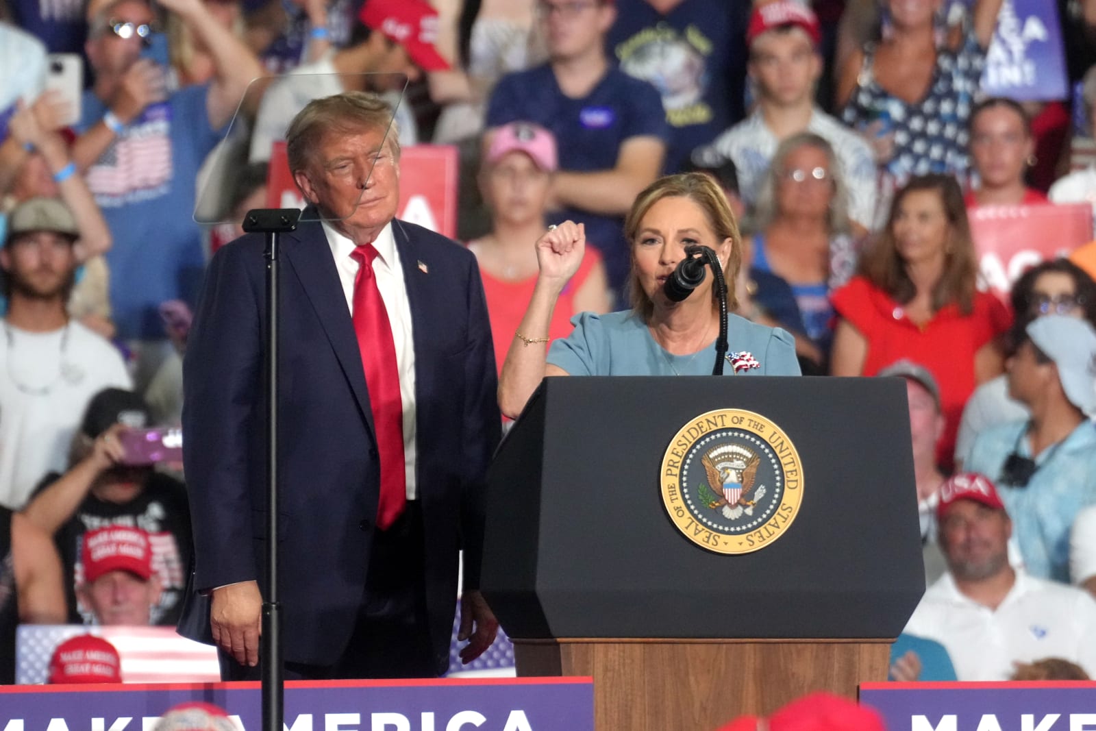 President Donald Trump, left, looks on as Sen. Darline Graham. R-S.C., speaks at a campaign rally as she competes in a special Republican primary to replace her brother, the late Sen. Lindsey Graham, R-S.C., Friday, Aug. 21, 2026, in Myrtle Beach, S.C. (AP Photo/Meg Kinnard)