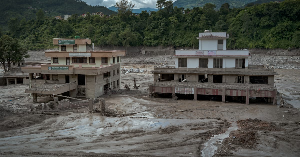 Damaged buildings are seen partially covered in heavy mud following flash floods on August 27, 2026, in Trishuli, Nepal (Getty Images)