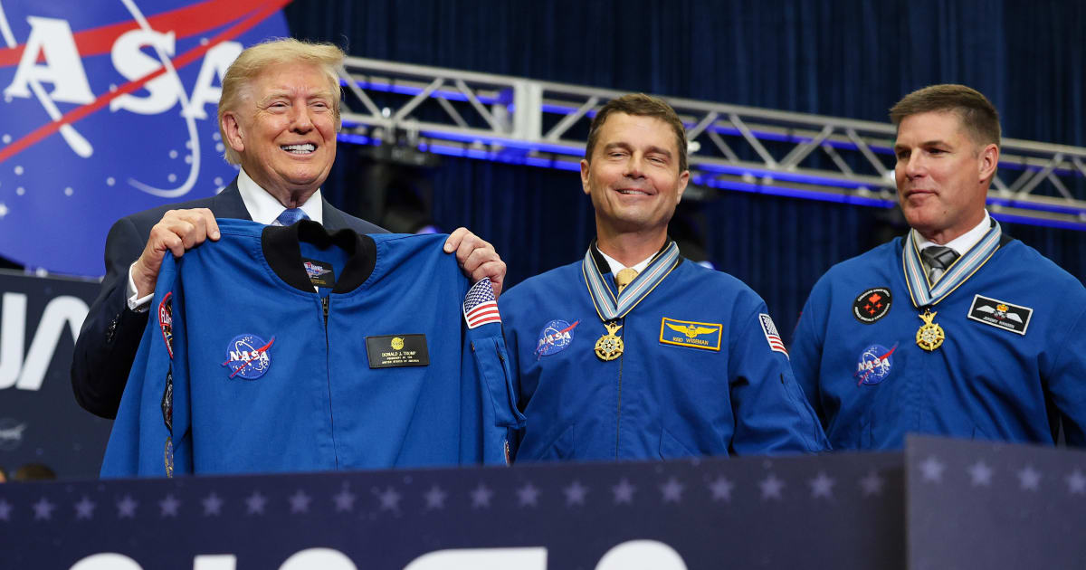 President Donald Trump holds up a flight jacket gifted to him by the Artemis II crew during a ceremony at NASA's Space Center in Houston (Getty Images)
