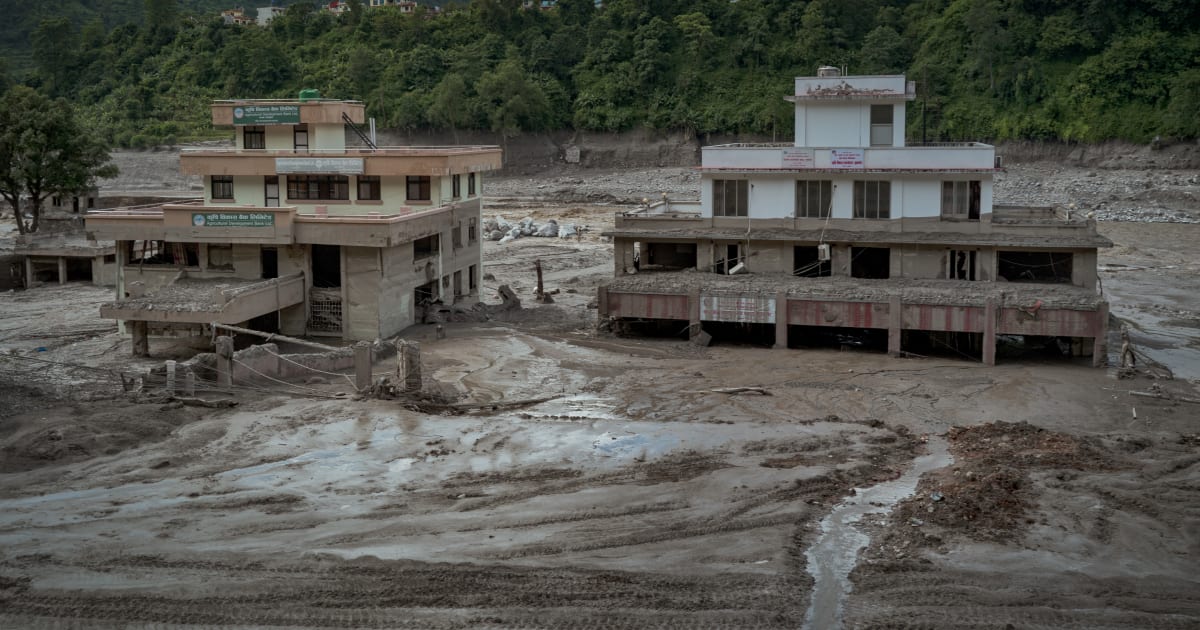Damaged buildings are seen partially covered in heavy mud following flash floods on August 27, 2026 in Trishuli, Nepal (Getty Images)