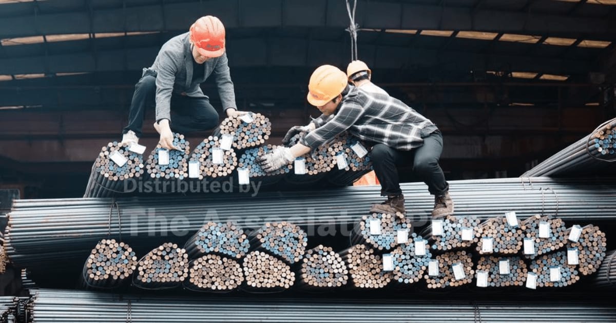 Workers lift steel at a steel market on March 31, 2026, in Hangzhou, Zhejiang Province of China (Long Wei/VCG via AP )