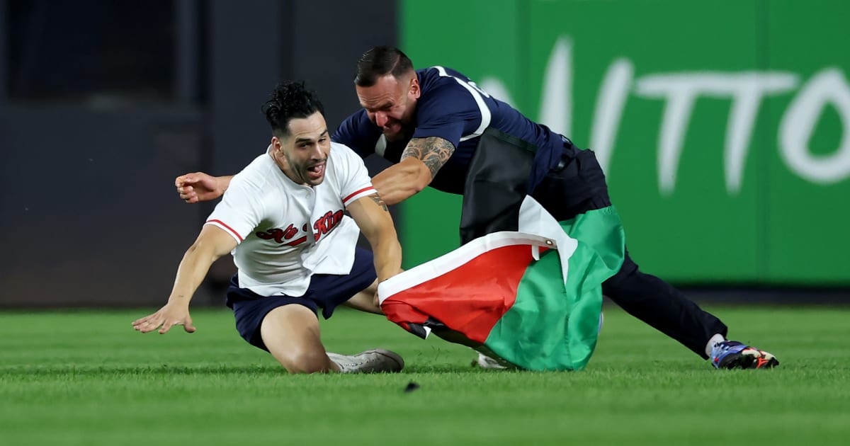 A fan carrying a Palestinian flag runs onto the field in the middle of the seventh inning at Yankee Stadium on September 11, 2026, in The Bronx borough of New York City (Getty Images)