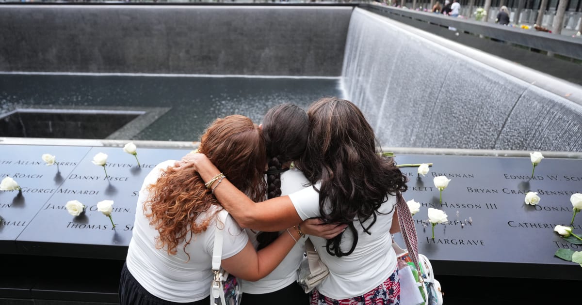 9/11 victim families stand at a reflecting pool on the 25th anniversary of the September 11th attacks on the World Trade Center in New York (Getty Images)