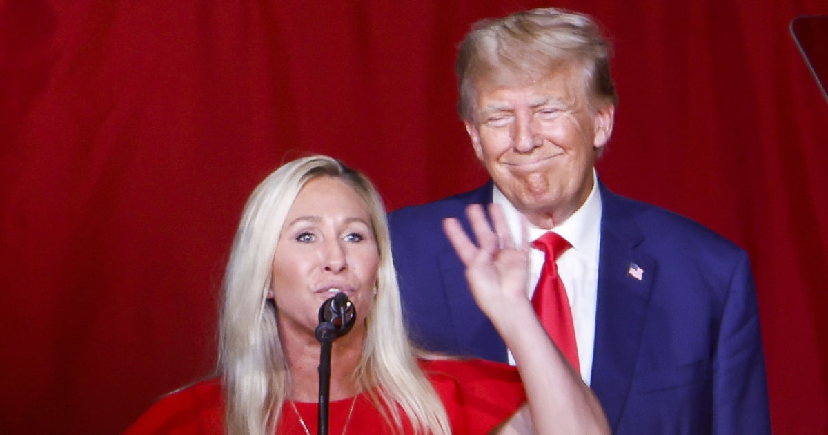 Donald Trump looks on as Marjorie Taylor Greene speaks during his remarks at the Georgia state GOP convention at the Columbus Convention and Trade Center on June 10, 2023, in Columbus, Georgia (Anna Moneymaker/Getty Images)