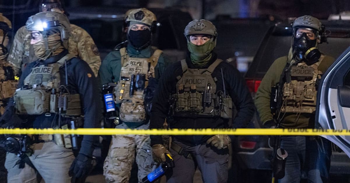 Federal agents guard a perimeter following a shooting incident as angry residents protest their presence in the city on January 14, 2026, in Minneapolis, Minnesota (Getty Images)