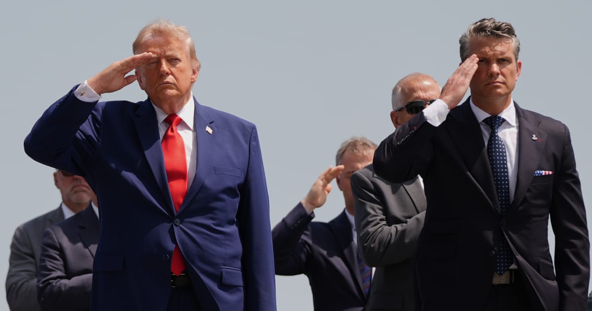 President Donald Trump and Defense Secretary Pete Hegseth salute as a US Army carry team moves a transfer case on Wednesday, July 22, 2026 (AP Photo/Julia)
