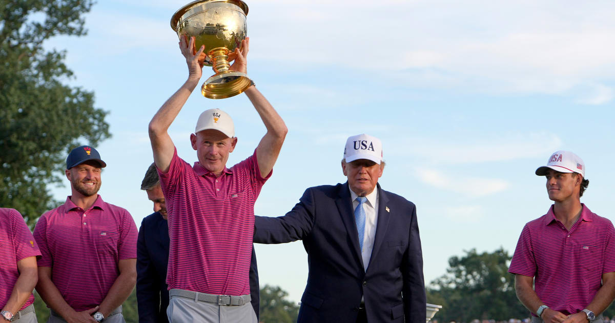 USA team captain Brandt Snedeker holds up the Presidents Cup trophy, presented by President Donald Trump, at the Presidents Cup golf tournament at Medinah Country Club on Sunday, September 27 (AP Photo/Julia Demaree Nikhinson)