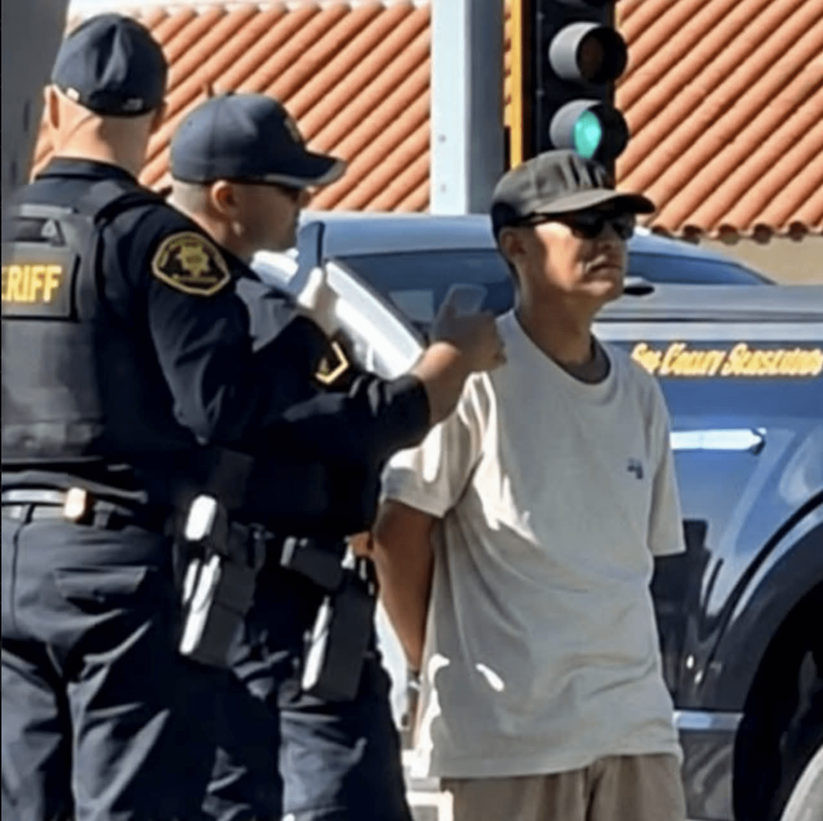 Shouyong Zhang is pictured being detained by police following the fatal shooting of New York Times executive Jonathan McKinsey