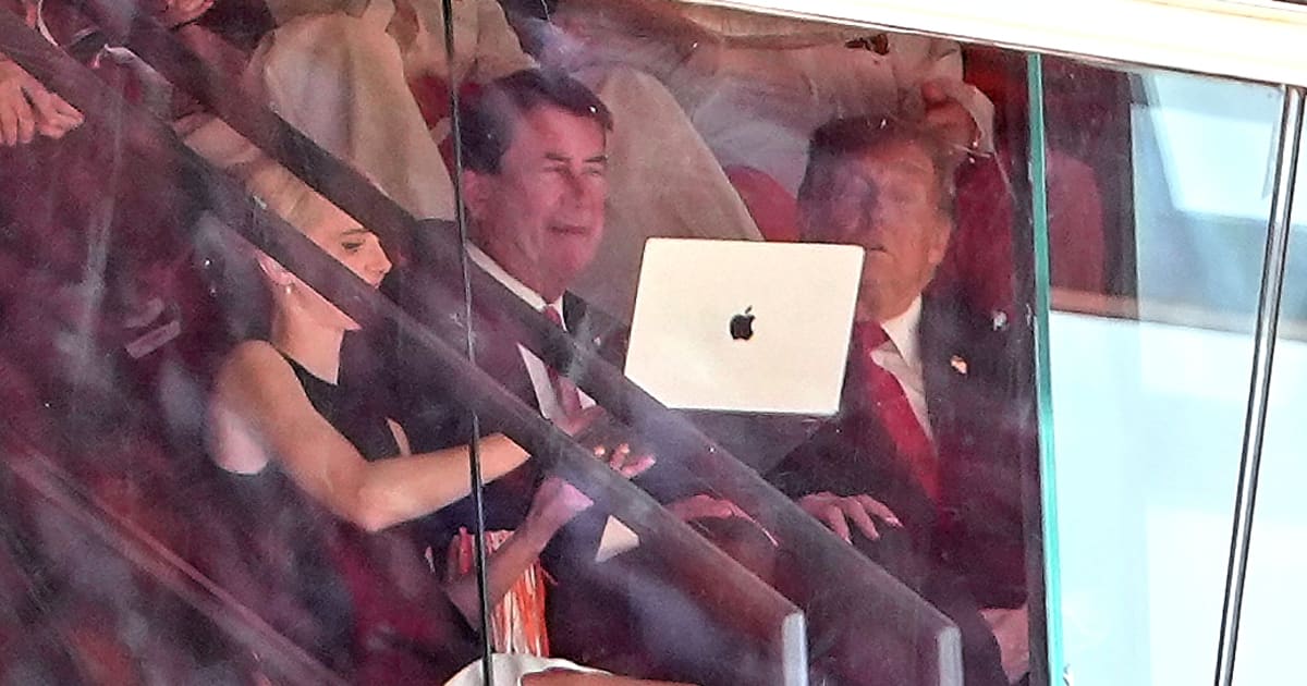 White House aide Natalie Harp, left, holds up a laptop for President Donald Trump, right, and Sen Bill Hagerty, R-Tenn, center (AP Photo/Julia Demaree Nikhinson)