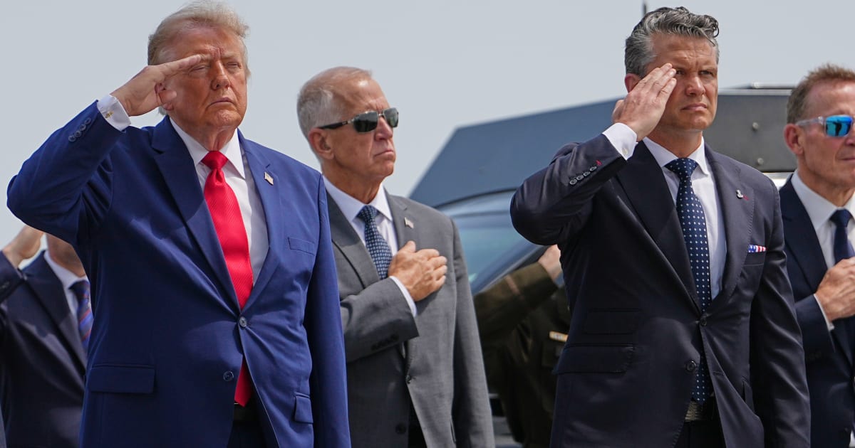 President Donald Trump, Secretary of Defense Pete Hegseth and others, salutes as a US Army carry team moves a transfer case, Texas, Wednesday, July 22, 2026, at Dover Air Force Base, Del (AP Photo/Matt Rourke)