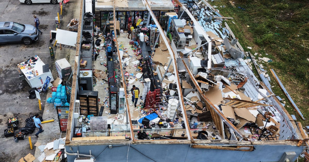 Residents salvaged goods from their destroyed mini mart in Milton, Florida, on October 10, 2026 (AP Photo/Gerald Herbert)