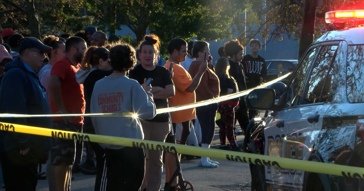 In this image from video provided by WJET, bystanders gather outside the scene of a shooting in Erie, Pa., on Friday evening, Oct. 9, 2026 (Matt Barnum/WJET via AP)